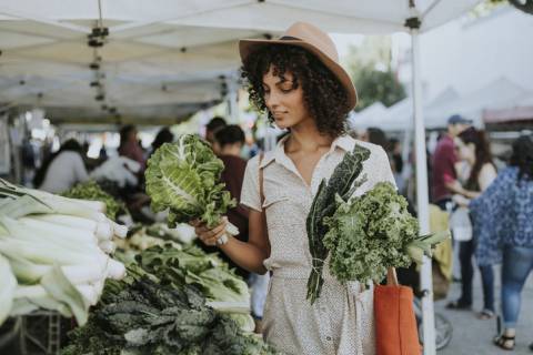 A woman buys produce at the Santa Fe farmers market A woman buys produce at the Santa Fe farmers market