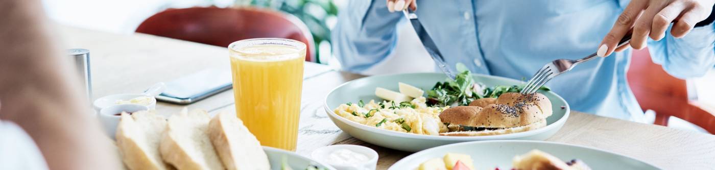 A couple sits down at breakfast